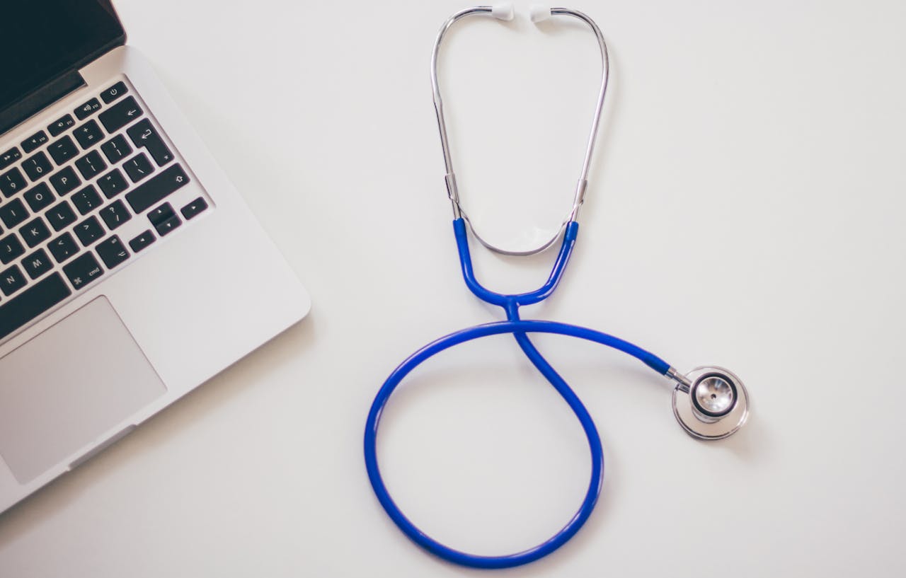 why-choose-us-02 Medical stethoscope and laptop on a white desk, symbolizing digital health solutions.